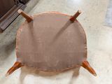 a close up of a wooden chair with a brown seat
