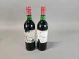 two bottles of wine sitting next to each other on a table