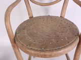 a wooden chair with holes in the back of it