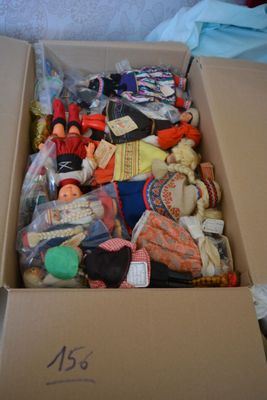 a cardboard box filled with assorted toys on the floor