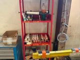 a red shelf with tools on it in a garage