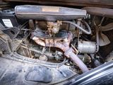 an old car engine with a rusted hood