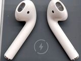 an apple airpods sitting on top of a table next to a charger