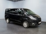 the black van is parked in a large room with white walls
