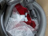 a vacuum that is sitting in a box with a stuffed animal inside of it