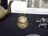 a gold teapot and a silver tea pot on a table