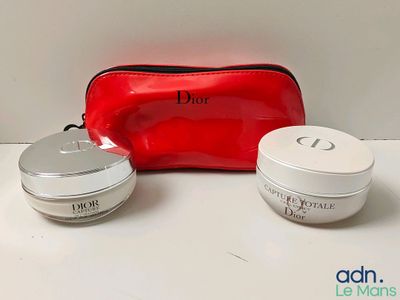 Produits de soin Christian Dior présentés sur une table, accompagnés d'un sac rouge