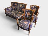 three chairs and a couch with a floral upholstered back