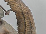 a statue of an angel holding a sword and a shield