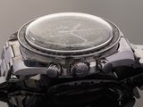 a close up of a watch on a black surface