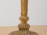 a gold lamp that is on a wooden table