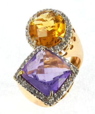 an image of a close up of a ring with two different colored stones