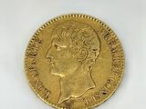 a close up of a gold coin on a white surface