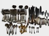 many different types of silverware on the table