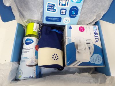 a blue box containing a bottle of water, a bottle of spray, a bottle of toothpaste, a toothbrush, and a toothbrush