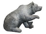 a statue of a bear that is sitting on a rock
