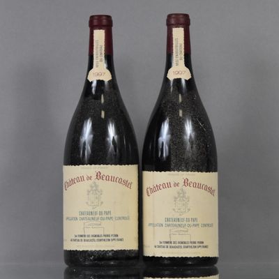 two bottles of red wine sitting next to each other on a table