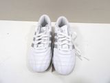pair of white tennis shoes on a white surface with a white background