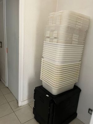 a stack of plastic containers sitting on top of a black box