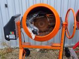an orange cement mixer sitting on the side of a building