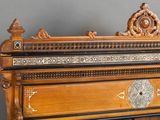 a large wooden bed with intricate carvings on it