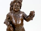 bronze statue of a boy holding a cup and a jug
