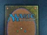 the back of a magic the gathering card with a picture of a smiling face