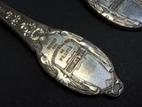 two spoons that are sitting on a table