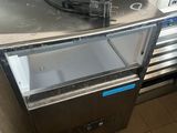 a small refrigerator with a metal top in a kitchen
