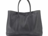 a black leather tote bag on a white background