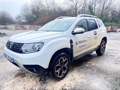 une photo d'une Dacia blanche garée sur un parking