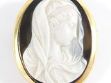 an image of a woman wearing a veil in a black and white cameo broochle