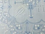 an image of a blue and white table cloth with a cross on it