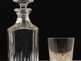 a glass and a decanter on a table