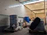a large room with a lot of boxes and barrels on the floor
