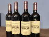 three bottles of red wine are lined up on a table