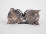 pair of silver figurines of elephants on a white background