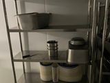 a shelf with pots and pans on it in a kitchen