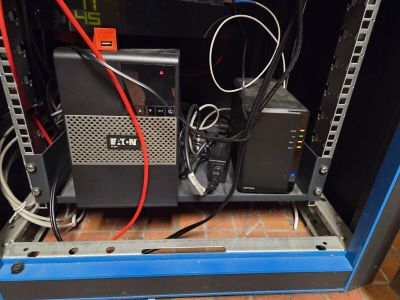 a rack with a lot of wires in it that is attached to a wall