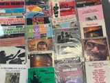 a lot of music cds and cds on the table