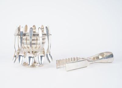 a silver object that is sitting next to a toothbrush