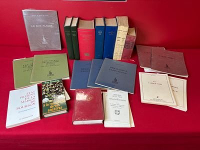 many books on a red table with a red chair