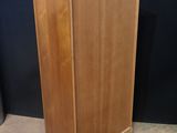 an image of a wooden cabinet sitting on top of a carpeted floor