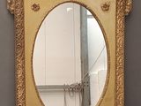 an image of a mirror with a gold frame on a grey background