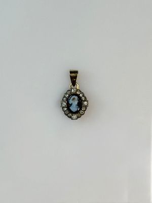 a close up of a small pendant with a face on it