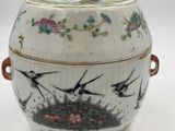 a white bowl with birds and flowers on it