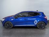 a blue car is parked in a room with a white wall
