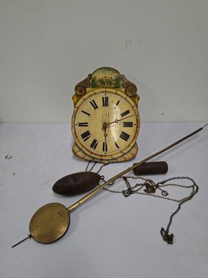 a clock that is sitting on a table with a chain around it