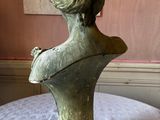 sculpture of a woman ' s head on a table in a room