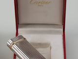 a silver lighter in a red box on a table